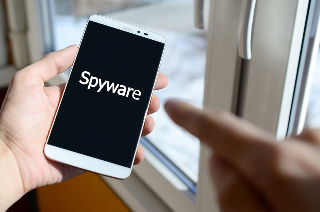 a-person-sees-a-white-inscription-on-a-black-smartphone-display-that-holds-in-his-hand-spyware-1024x678