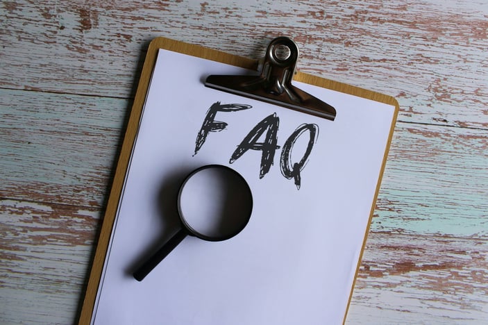 paper-clipboard-with-text-faq-or-frequently-asked-question-and-magnifying-glass-