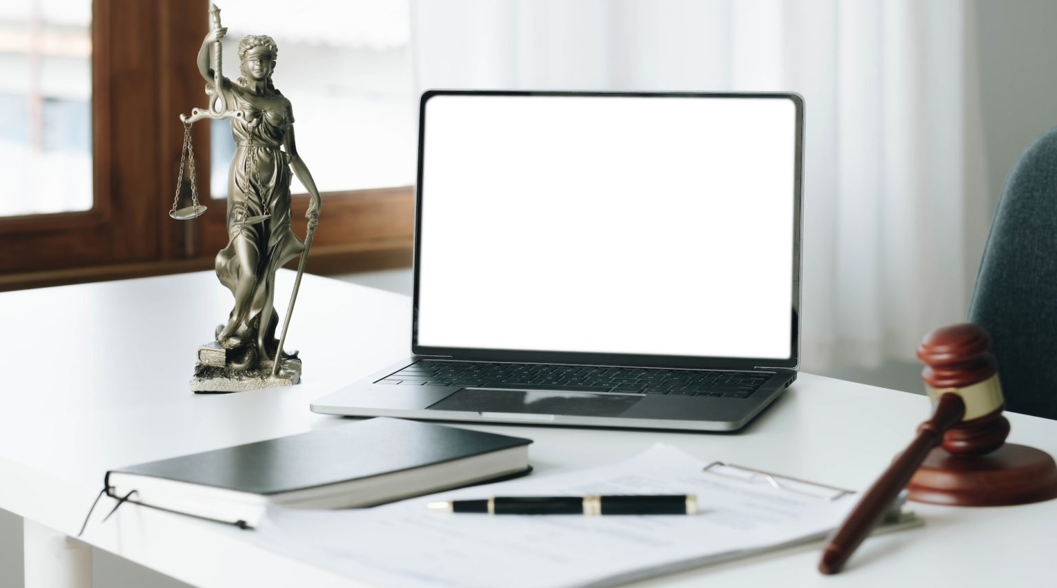 workspace-of-lawyer-with-laptop-blank-white-screen-and-law-wooden-gavel-legal-book-and-brass-scale-1536x855