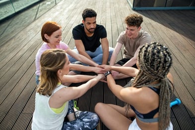 young-people-doing-exercise-stacking-hands-outdoors-on-terrace-sport-and-healthy-lifestyle-concept--1024x681